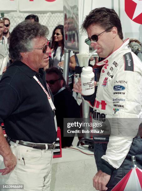 Racer Michael Andretti speaks with his father Mario Andretti prior to the Long Beach Grand Prix Race, April 11, 1997 in Long Beach, California.