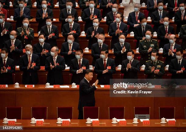 Chinese President Xi Jinping is applauded as he waves to senior members of the government upon arrival at the Opening Ceremony of the 20th National...