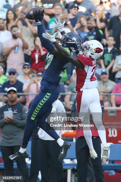 Tariq Woolen of the Seattle Seahawks intercepts a pass intended for Marquise Brown of the Arizona Cardinals during the fourth quarter at Lumen Field...