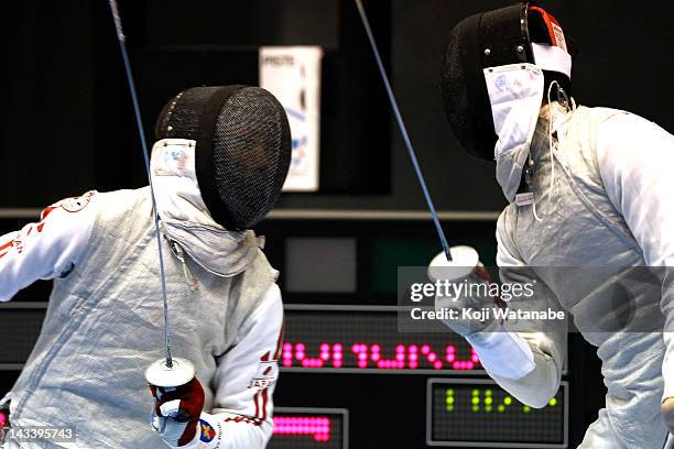 Ryo Miyake of Japan competes against Cheung Siu Lun of Hong Kong in the Men's Foil Team Tableau of 3rd place on day four of the 2012 Asian Fencing...