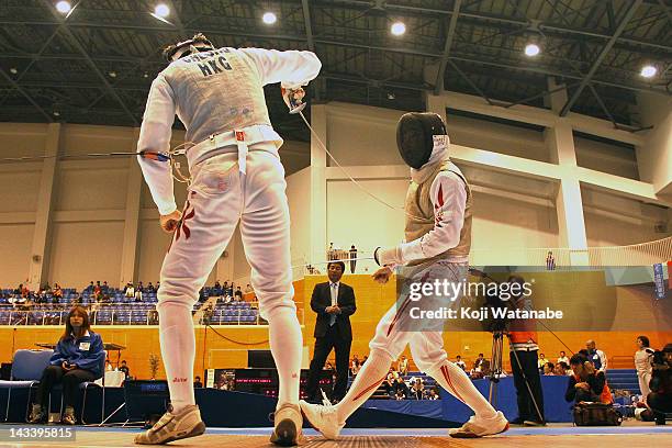 Taku Awaji of Japan competes against Cheung Siu Lun of Hong Kong in the Men's Foil Team Tableau of 3rd place on day four of the 2012 Asian Fencing...