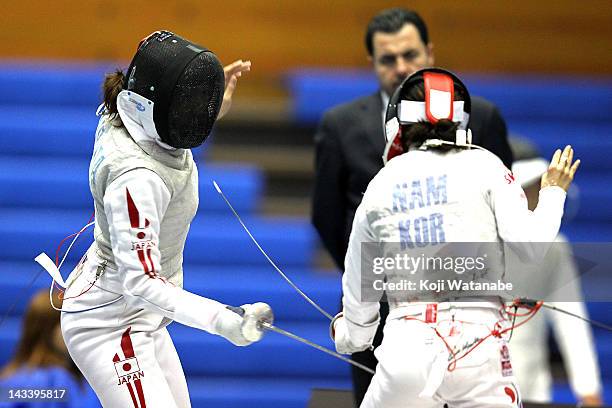 Kyomi Hirata of Japan competes against Nam Hyun Hee of South Korea in the Women's Foil Team Tableau of final on day four of the 2012 Asian Fencing...