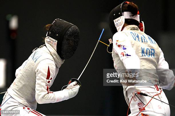 Siho Nishioka of Japan competes against Jung Gil Ok of South Korea in the Women's Foil Team Tableau of final on day four of the 2012 Asian Fencing...