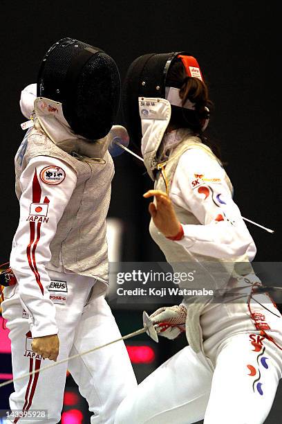 Chieko Sugawara of Japan competes against Jung Gil Ok of South Korea in the Women's Foil Team Tableau of final on day four of the 2012 Asian Fencing...