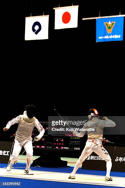 Chieko Sugawara of Japan competes against Nam Hyun Hee of South Korea in the Women's Foil Team Tableau of final on day four of the 2012 Asian Fencing...