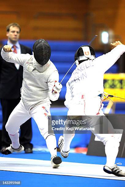 Ha Tae-Kyu of South Korea competes against Huang Liangcai of China in the Men's Foil Team Tableau of final on day four of the 2012 Asian Fencing...
