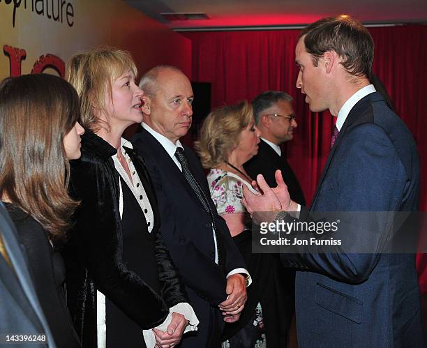 Prince William, Duke of Cambridge meets musician Mark Knopfler and his wife Kitty Aldridge as he attends the "African Cats" UK film Premiere in Aid...