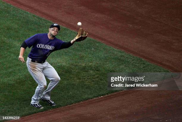 Michael Cuddyer of the Colorado Rockies catches a fly ball near foul territory against the Pittsburgh Pirates during the second game of a...