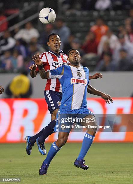 Gabriel Gomez of Philadelphia Union tracks the ball under pressure from James Riley of Chivas USA in the first half during the MLS match at The Home...