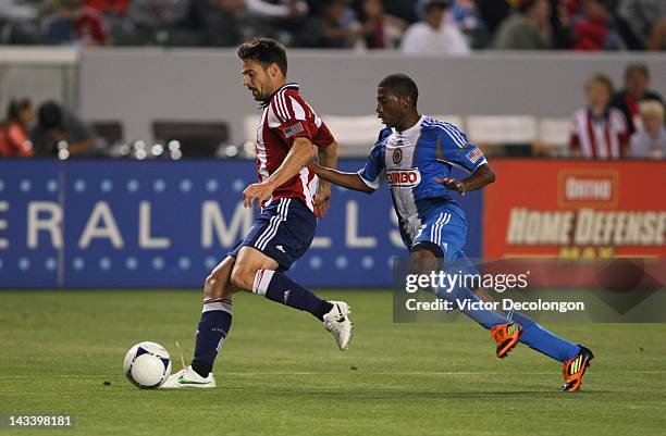 Heath Pearce of Chivas USA controls the ball under pressure from Raymon Gaddis of Philadelphia Union in the first half during the MLS match at The...