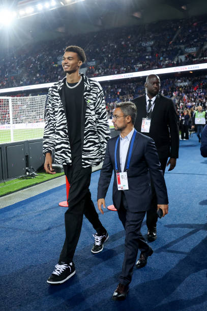 French basketball player Victor Wembanyama and his agent Jeremy Medjana attend the Ligue 1 match between Paris Saint-Germain and Olympique de...