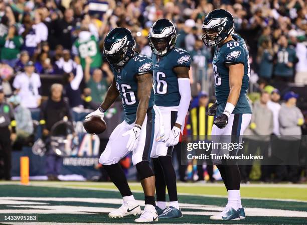 Miles Sanders, Quez Watkins and Dallas Goedert of the Philadelphia Eagles celebrate a touchdown by Sanders in the second quarter of the game agains...