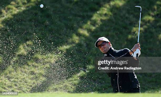 Adam Scott of Australia plays a bunker shot on the 13th hole during the first round of the Ballantine's Championship at Blackstone Golf Club on April...