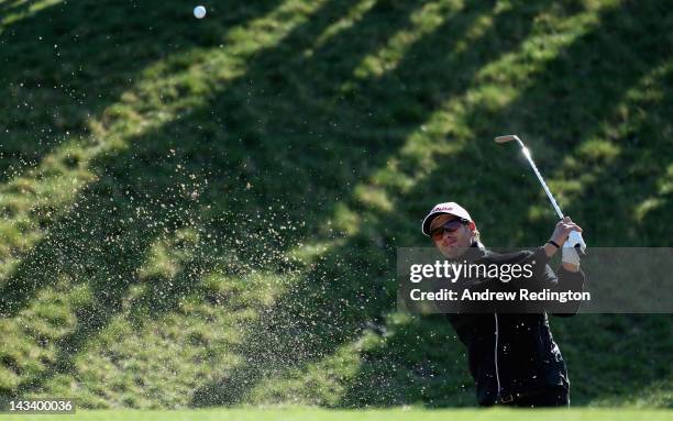 Adam Scott of Australia plays a bunker shot on the 13th hole during the first round of the Ballantine's Championship at Blackstone Golf Club on April...