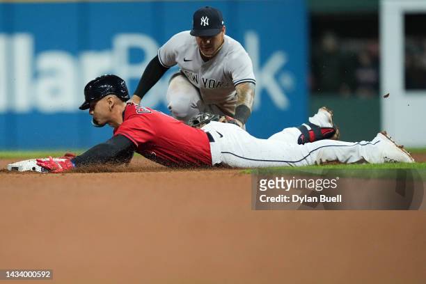 Andres Gimenez of the Cleveland Guardians slides to second base past Gleyber Torres of the New York Yankees during the seventh inning in game four of...