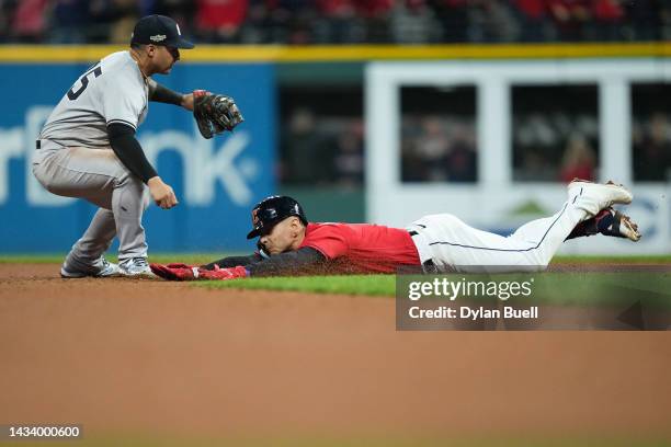 Andres Gimenez of the Cleveland Guardians slides to second base past Gleyber Torres of the New York Yankees during the seventh inning in game four of...