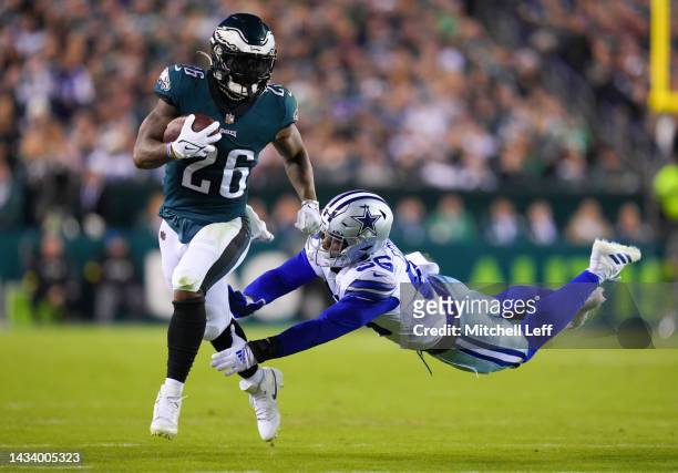 Miles Sanders of the Philadelphia Eagles runs the ball whilst Dante Fowler Jr. #56 of the Dallas Cowboys attempts the tackle in the second quarter of...