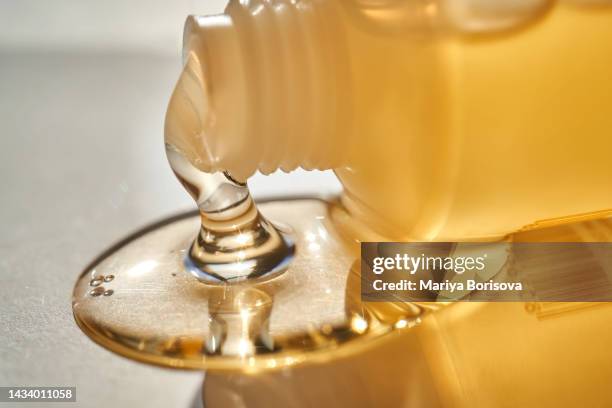 a tube of yellow gel. shower gel or cosmetic gel texture. - facial cleanser stockfoto's en -beelden