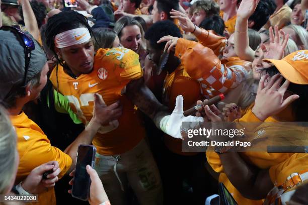 Linebacker Jeremy Banks of the Tennessee Volunteers gets a cigar from a fan after the game against the Alabama Crimson Tide at Neyland Stadium on...