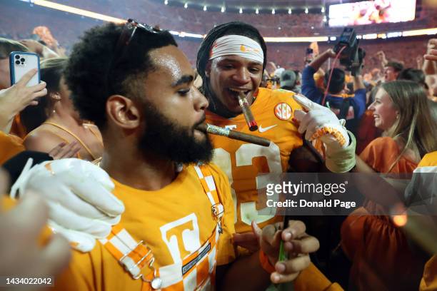 Linebacker Jeremy Banks of the Tennessee Volunteers gets a cigar from a fan after the game against the Alabama Crimson Tide at Neyland Stadium on...