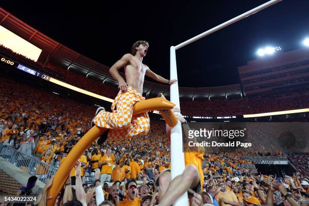 Tennessee Volunteers fans tear down the goal post while celebrating a win over the Alabama Crimson Tide at Neyland Stadium on October 15, 2022 in...