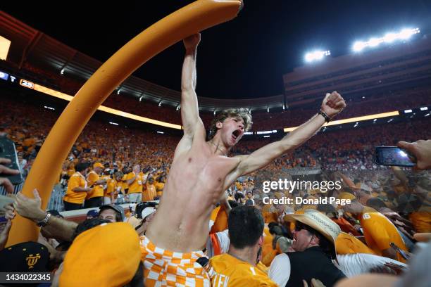 Tennessee Volunteers fans tear down the goal post while celebrating a win over the Alabama Crimson Tide at Neyland Stadium on October 15, 2022 in...