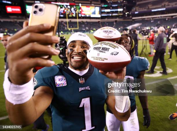 Jalen Hurts and C.J. Gardner-Johnson of the Philadelphia Eagles take a picture holding the game balls after defeating the Dallas Cowboys 26-17 in the...