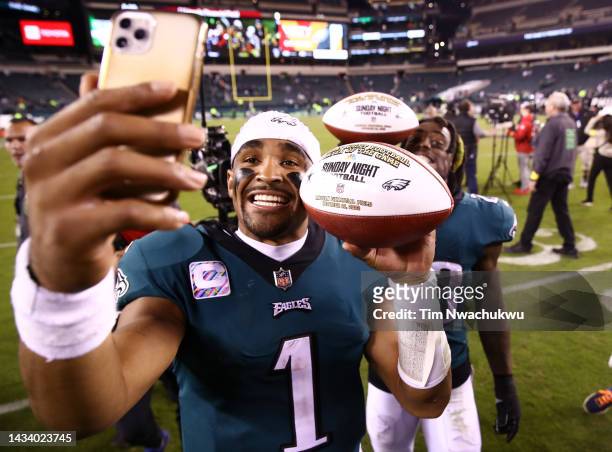 Jalen Hurts and C.J. Gardner-Johnson of the Philadelphia Eagles take a picture holding the game balls after defeating the Dallas Cowboys 26-17 in the...
