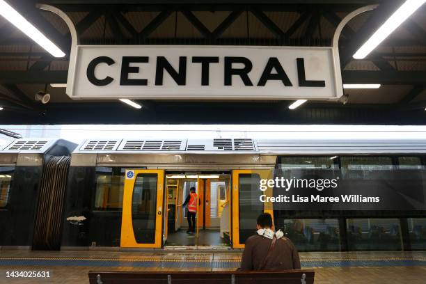 Commuter looks on as a train is cleaned at Central railway station on October 17, 2022 in Sydney, Australia. The New South Wales Government and rail...