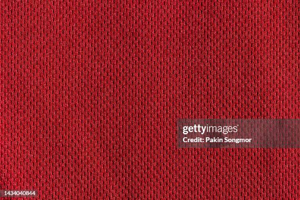 red color sports clothing fabric football shirt jersey texture and textile background. - jersey fabric stockfoto's en -beelden