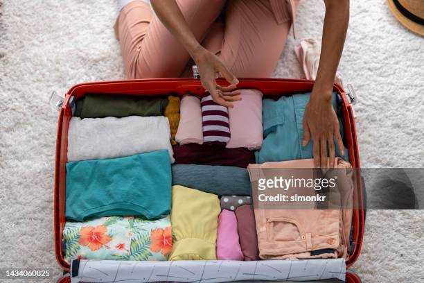 woman packing clothes - suitcase from above stock pictures, royalty-free photos & images