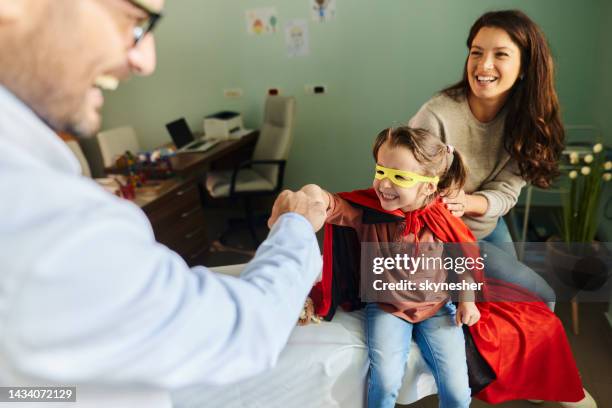 fist bumping with pediatrician! - mother congratulating stock pictures, royalty-free photos & images