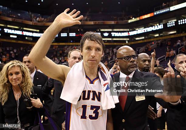 Steve Nash of the Phoenix Suns waves to fans as he walks off the court following the NBA game against the San Antonio Spurs at US Airways Center on...