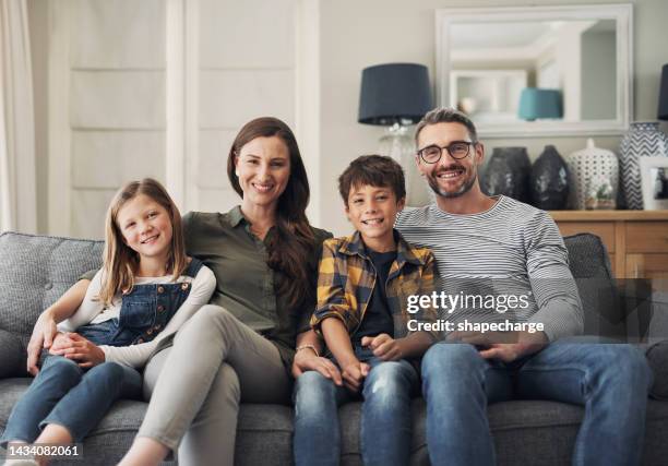 family, portrait smile and relax on living room sofa in happiness for bonding time together in the lounge at home. happy mother, father and children relaxing on a couch enjoying break at the house - fyra människor bildbanksfoton och bilder