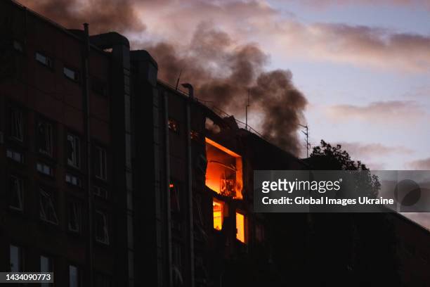 Fire rising on upper floors in damaged building following attack from “kamikaze drones” on October 17, 2022 in Kyiv, Ukraine. In the morning, 5...