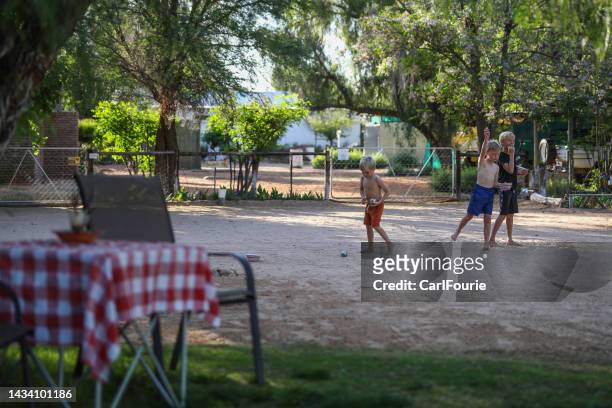 three brothers playing boule - petanque stock pictures, royalty-free photos & images