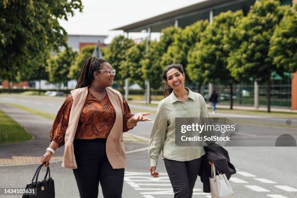 walking home after work with a friend - business casual outfit stock pictures, royalty-free photos & images