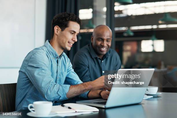 teamwork, diversity and sales manager planning branding ideas with a creative designer on a laptop in an office. logo, collaboration and businessman talking to an employee about a development project - kijken stockfoto's en -beelden