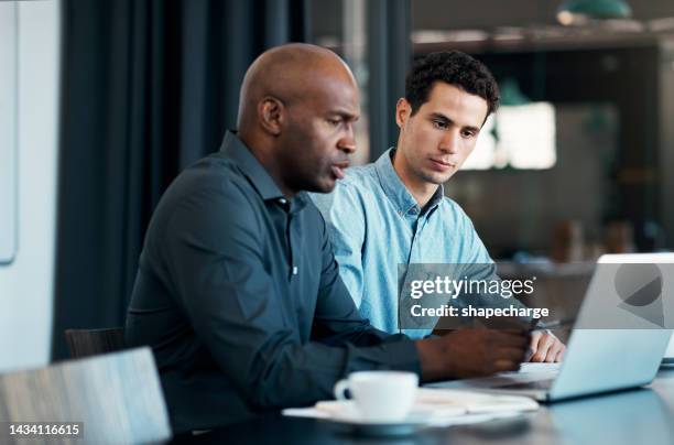 diversity, laptop and two men consulting at desk in startup office. strategy, planning and advice from business advisor, coach or manager. partnership, teamwork and collaboration on online project. - content development stock pictures, royalty-free photos & images