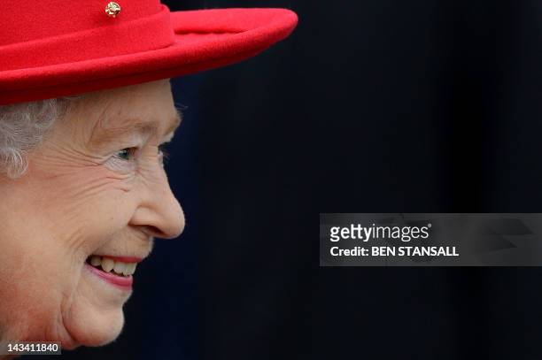 Britain's Queen Elizabeth II smiles as she attends the re-opening of the 'Cutty Sark' tea clipper in Greenwich, east London, on April 25, 2012. The...