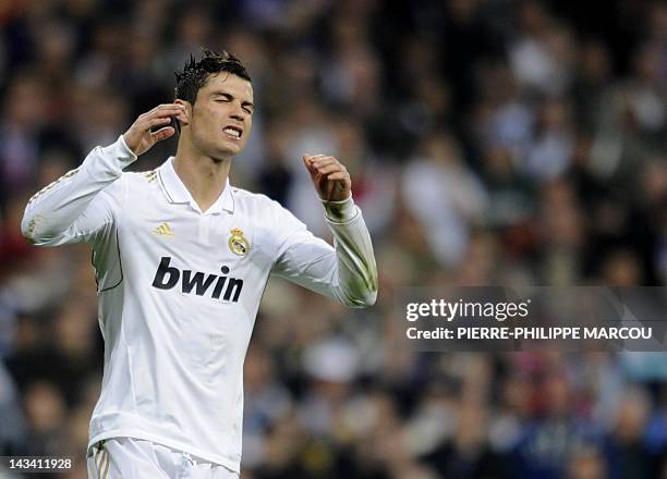Real Madrid's Portuguese forward Cristiano Ronaldo reacts after missing his penalty during the penalty shoot out at the UEFA Champions League second...
