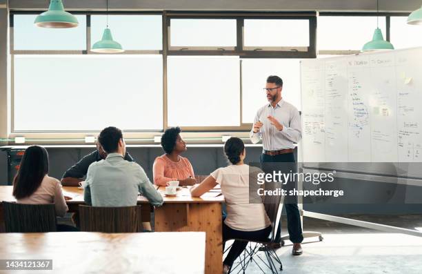 planning, strategy and a whiteboard presentation by a businessman coaching on financial growth in a meeting. seo leader training team with marketing ideas to staff in training in a conference room - meeting board room stock pictures, royalty-free photos & images