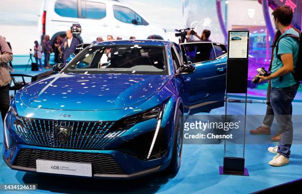 Peugeot 408 hybrid electric automobile is on display during the "Mondial de l'Automobile" at the Parc des Expositions on October 17, 2022 in Paris,...