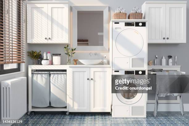 banheiro moderno com máquina de lavar roupa, secadora, armários brancos e rack de secagem - máquina de lavar roupa - fotografias e filmes do acervo