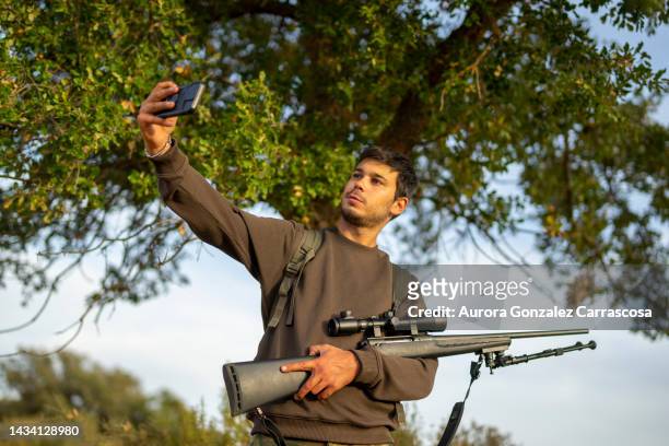day in the field, boy hunting big game. - boy taking picture in forest stock-fotos und bilder