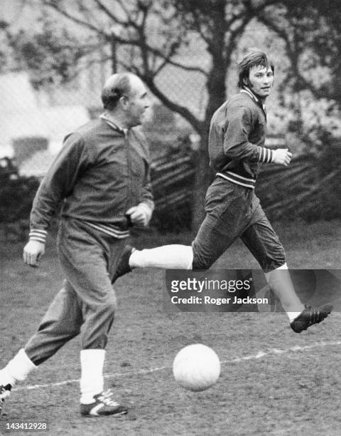 England manager Alf Ramsey , with England player Colin Todd, during a training session at Roehampton, London, 1st April 1974. The team is preparing...