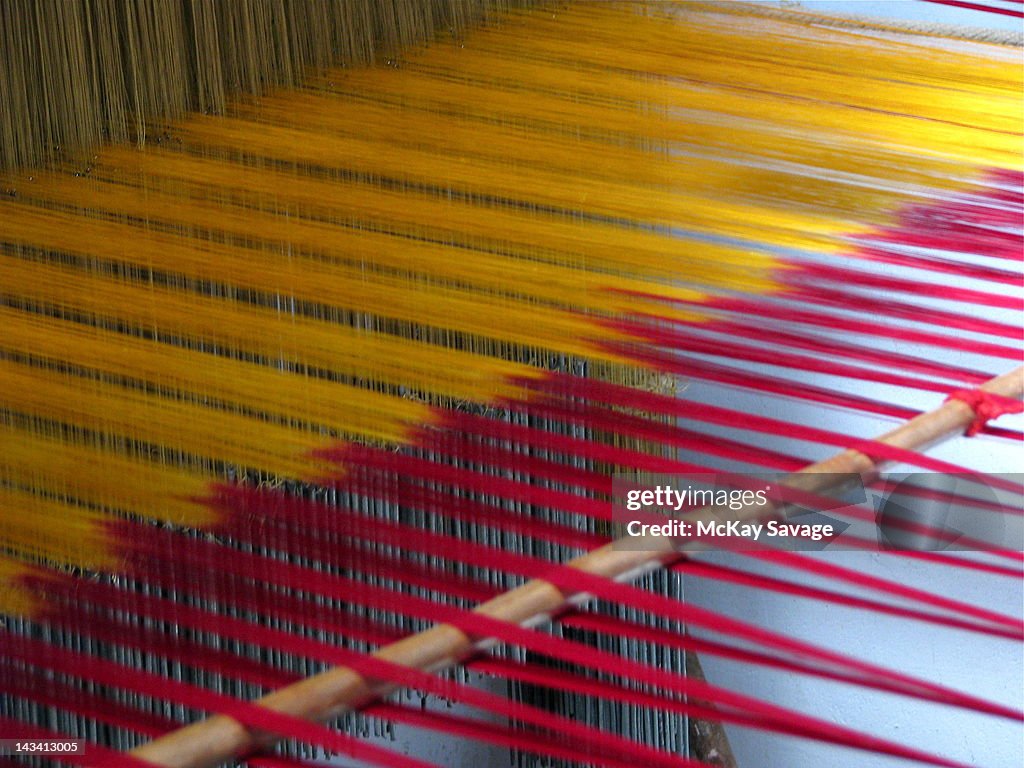 Silk sari threads strung on traditional loom