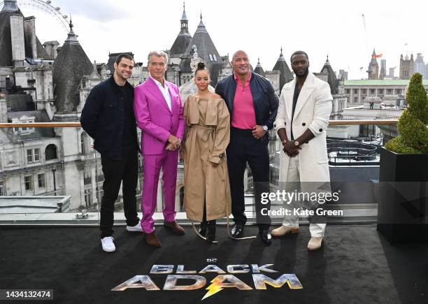 Noah Centineo, Pierce Brosnan, Quintessa Swindell, Dwayne Johnson aka The Rock, and Aldis Hodge attend the "Black Adam" photocall at The Corinthia...