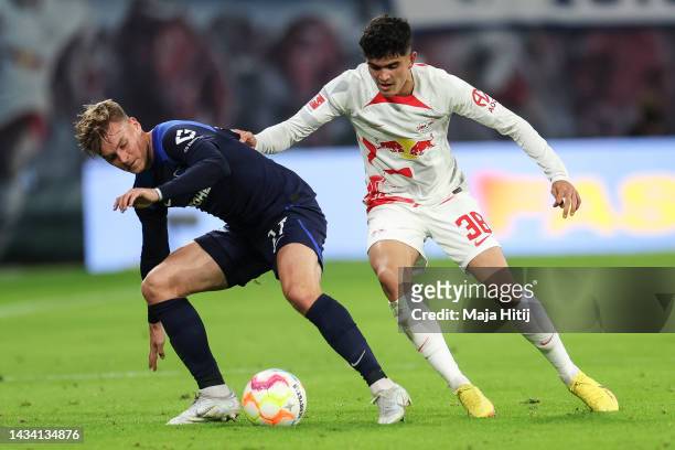 Maximilian Mittelstaedt of Hertha Berlin and Hugo Novoa Ramos of Leipzig battle for possession during the Bundesliga match between RB Leipzig and...