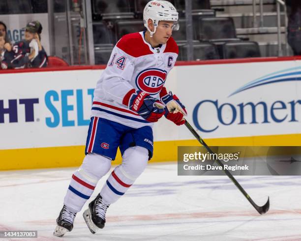 Nick Suzuki of the Montreal Canadiens skates around in warm ups before an NHL game against the Detroit Red Wings at Little Caesars Arena on October...